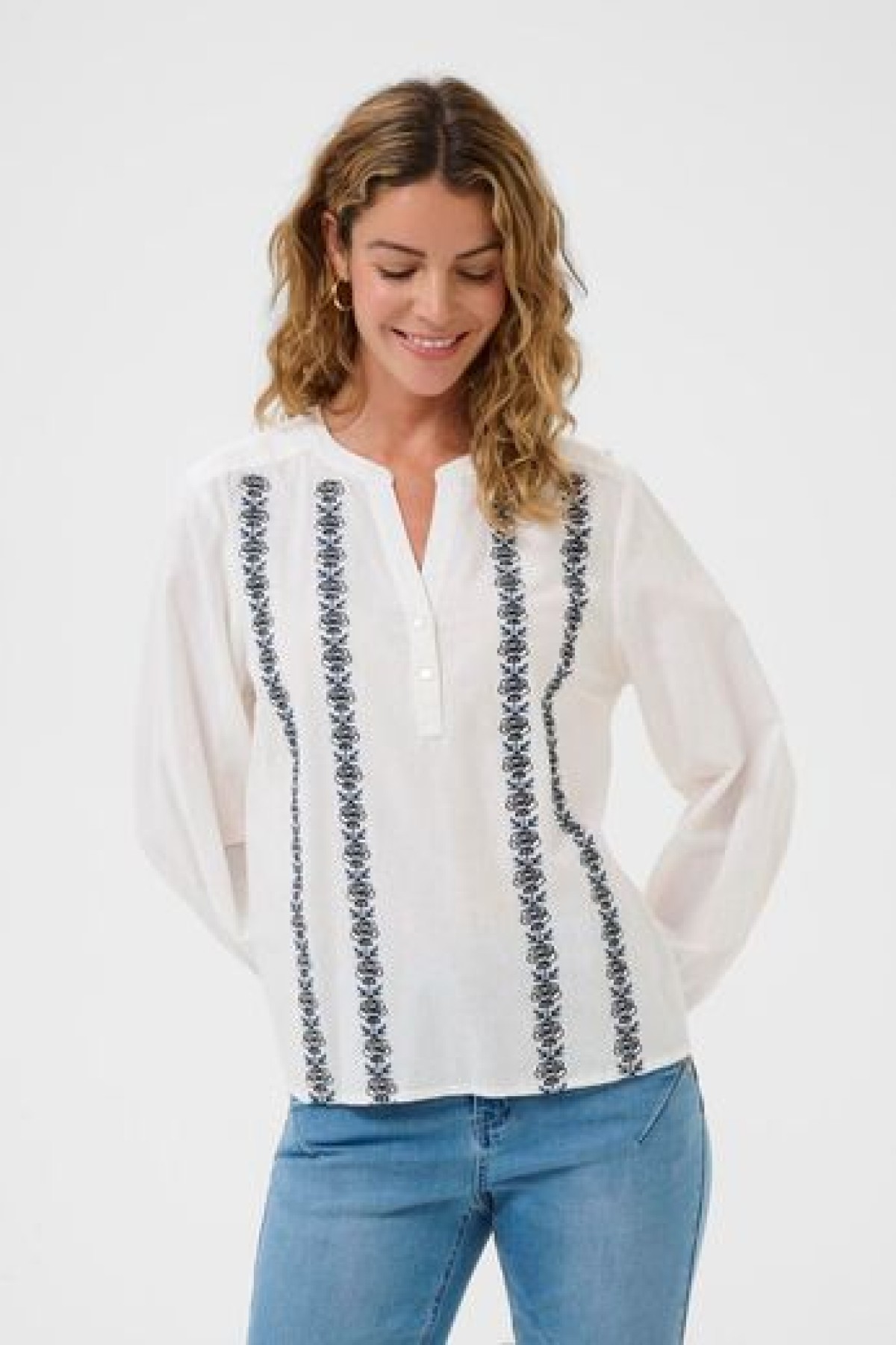 Cotton blouse with embroidery. It has a V-neck and a loose, comfortable fit.