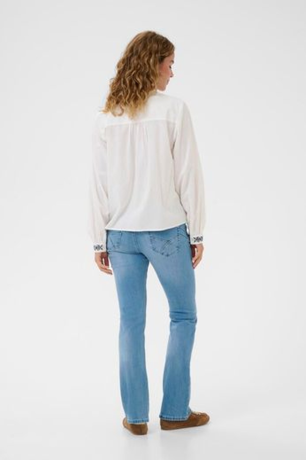 Cotton blouse with embroidery. It has a V-neck and a loose, comfortable fit.