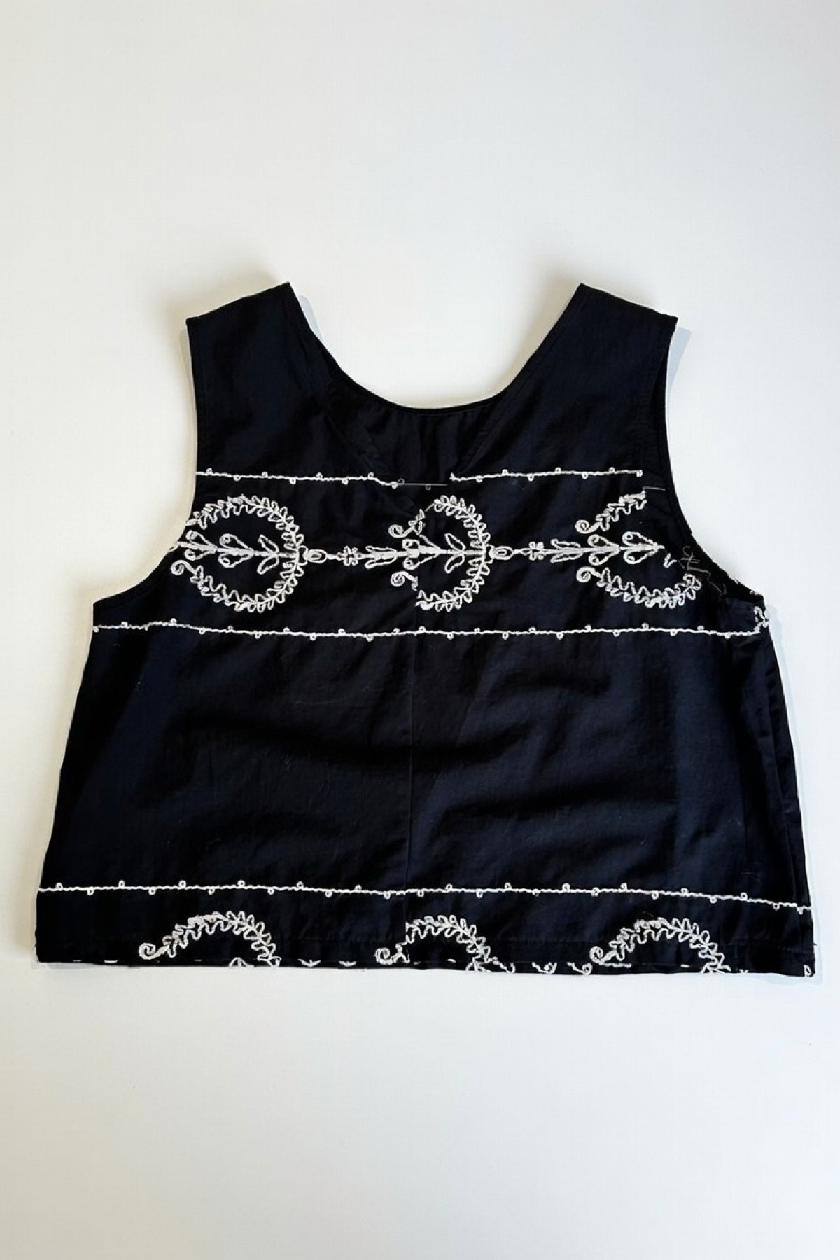 Sleeveless top with  white embroidery, wear it with the matching pants.