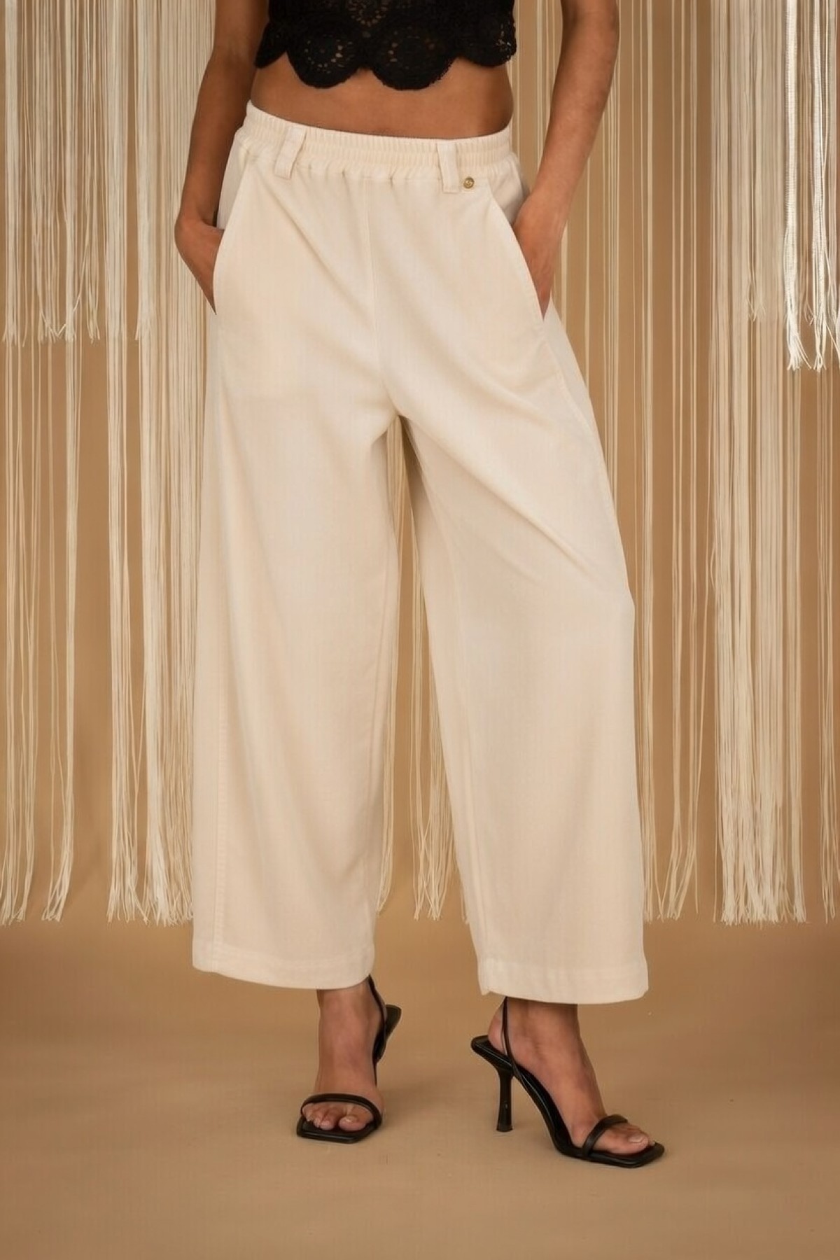 Wide-leg pants with elastic waist, available in black and ecru.