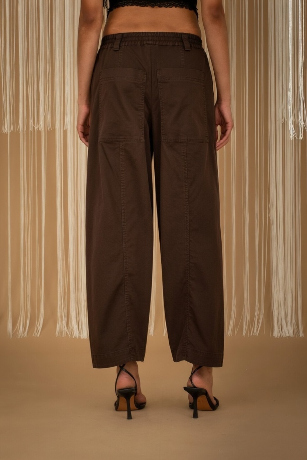 Wide-leg pants with elastic waist, available in black and ecru.
