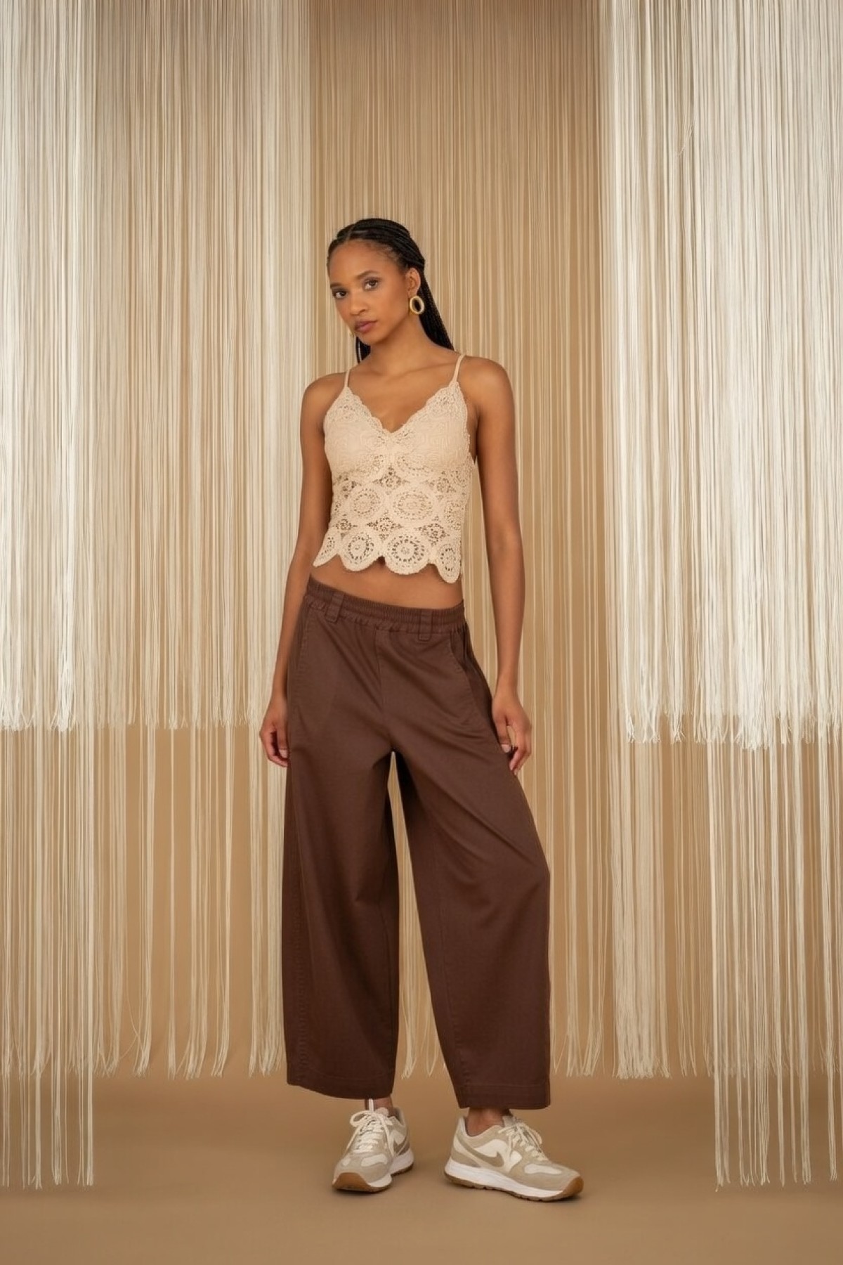 Wide-leg pants with elastic waist, available in black and ecru.