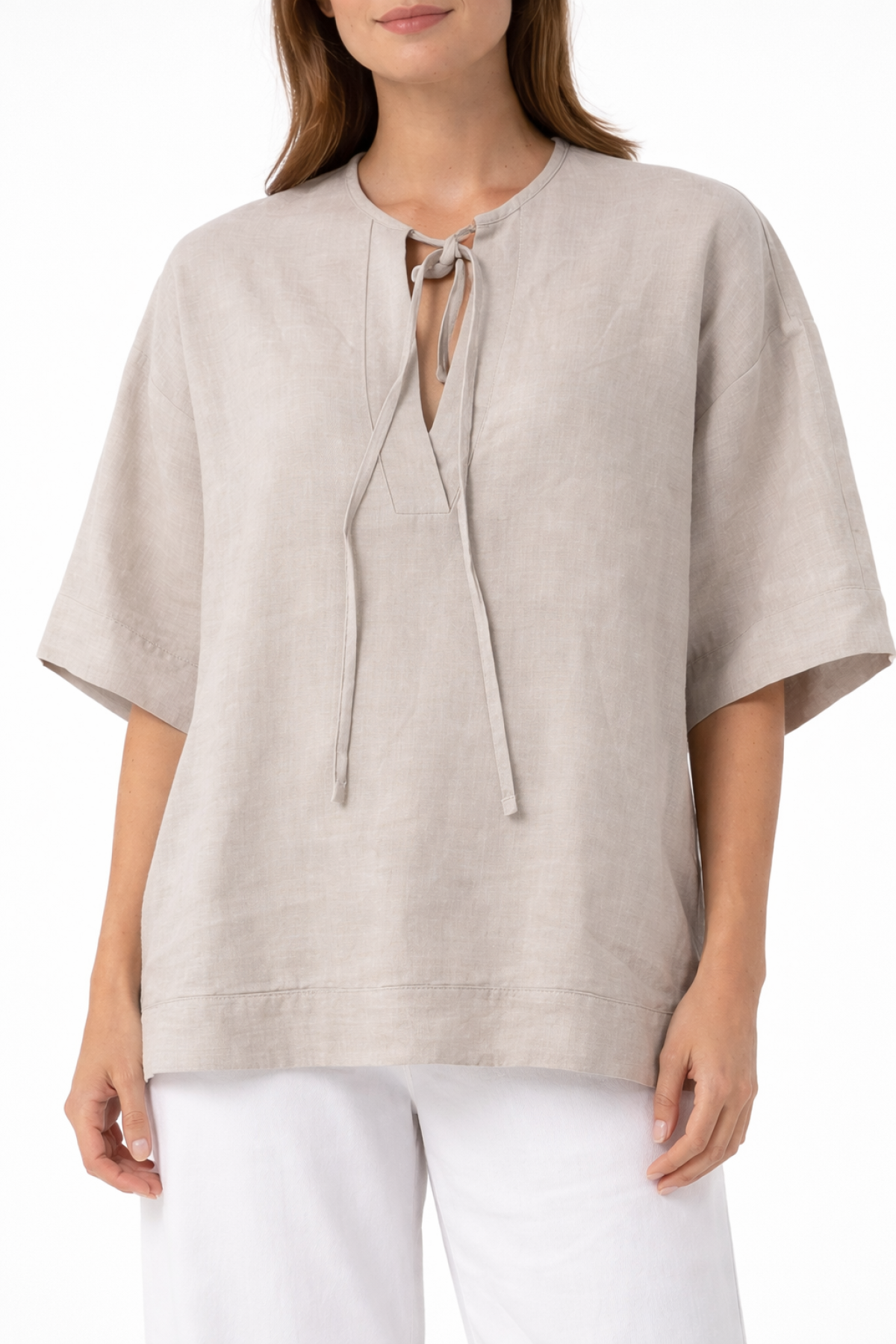 Relaxed blouse with wide sleeves, a round neckline, and a subtle front opening with tie strings.