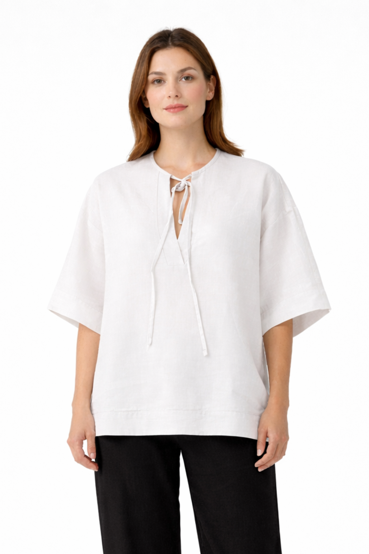 Relaxed blouse with wide sleeves, a round neckline, and a subtle front opening with tie strings.
