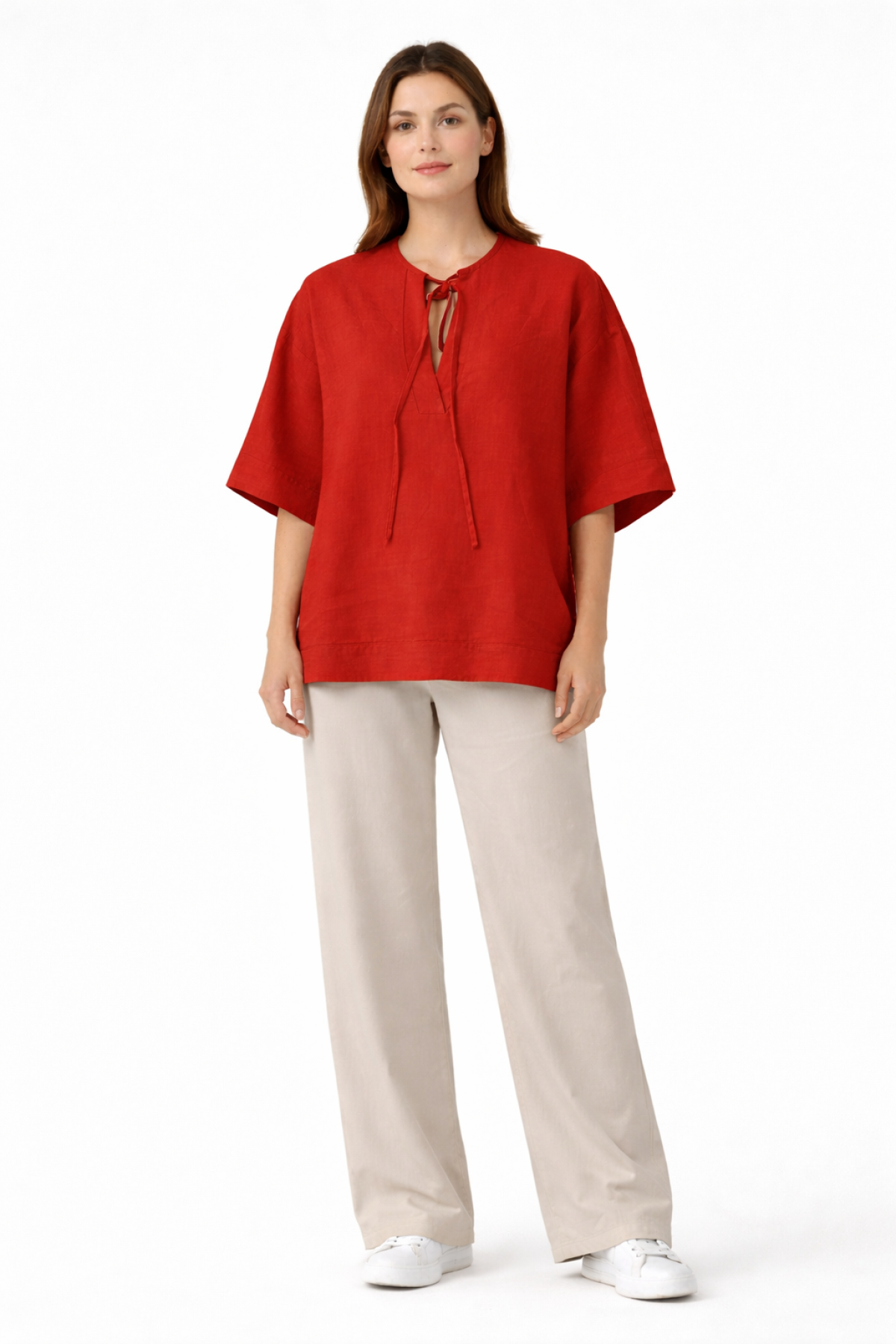 Relaxed blouse with wide sleeves, a round neckline, and a subtle front opening with tie strings.