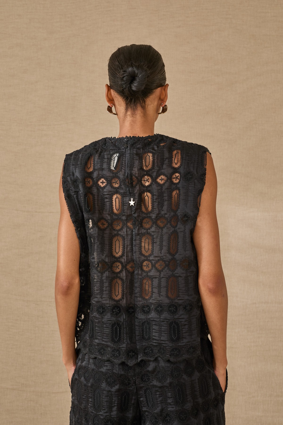 Μαύρο τoπ με ανάγλυφα σχέδια, συνδύασε το και με την παντελόνα  από την ίδια συλλογή