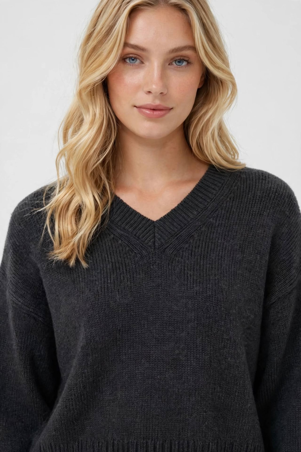 Oversized knit sweater in charcoal color with deep V-neckline