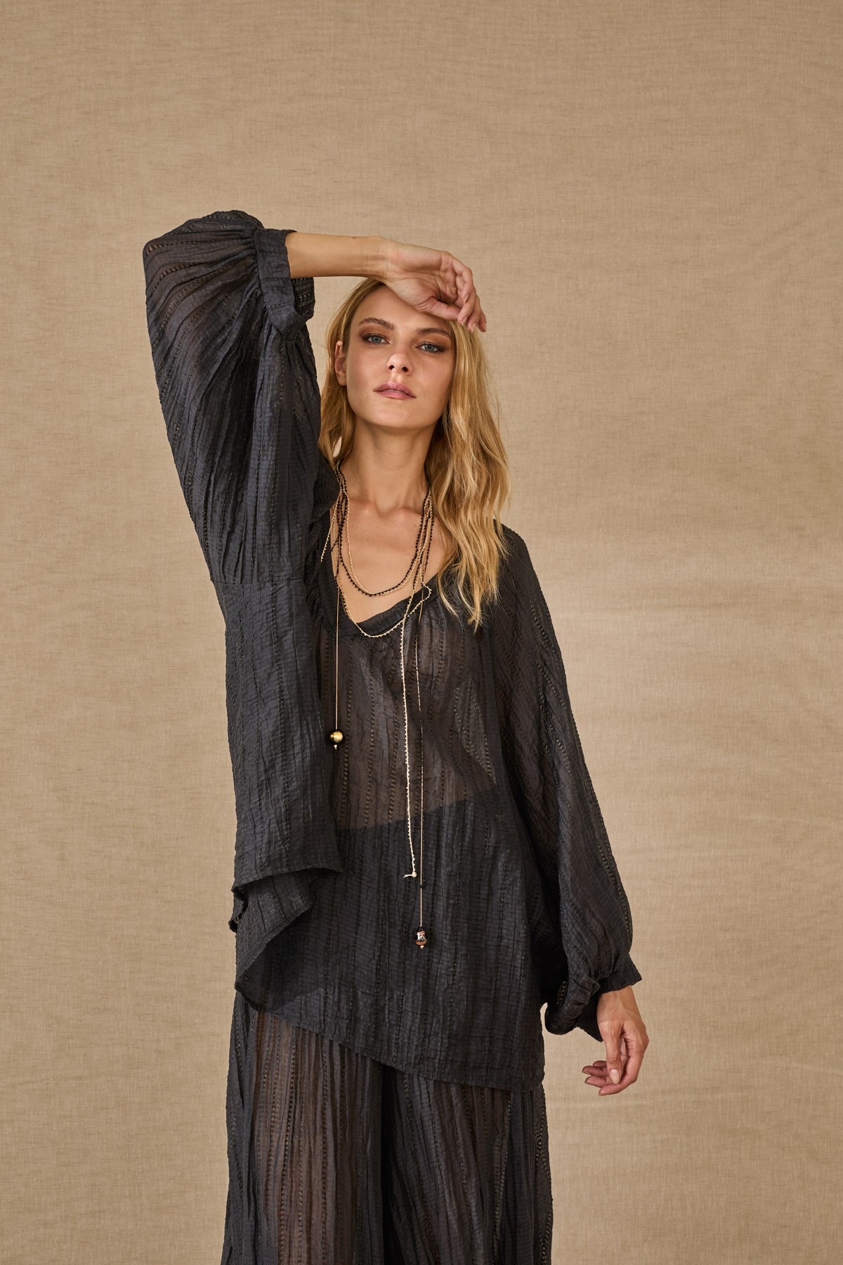 Light, flowy blouse with sleeves. For a complete look, pair them with the  pants from the same collection.