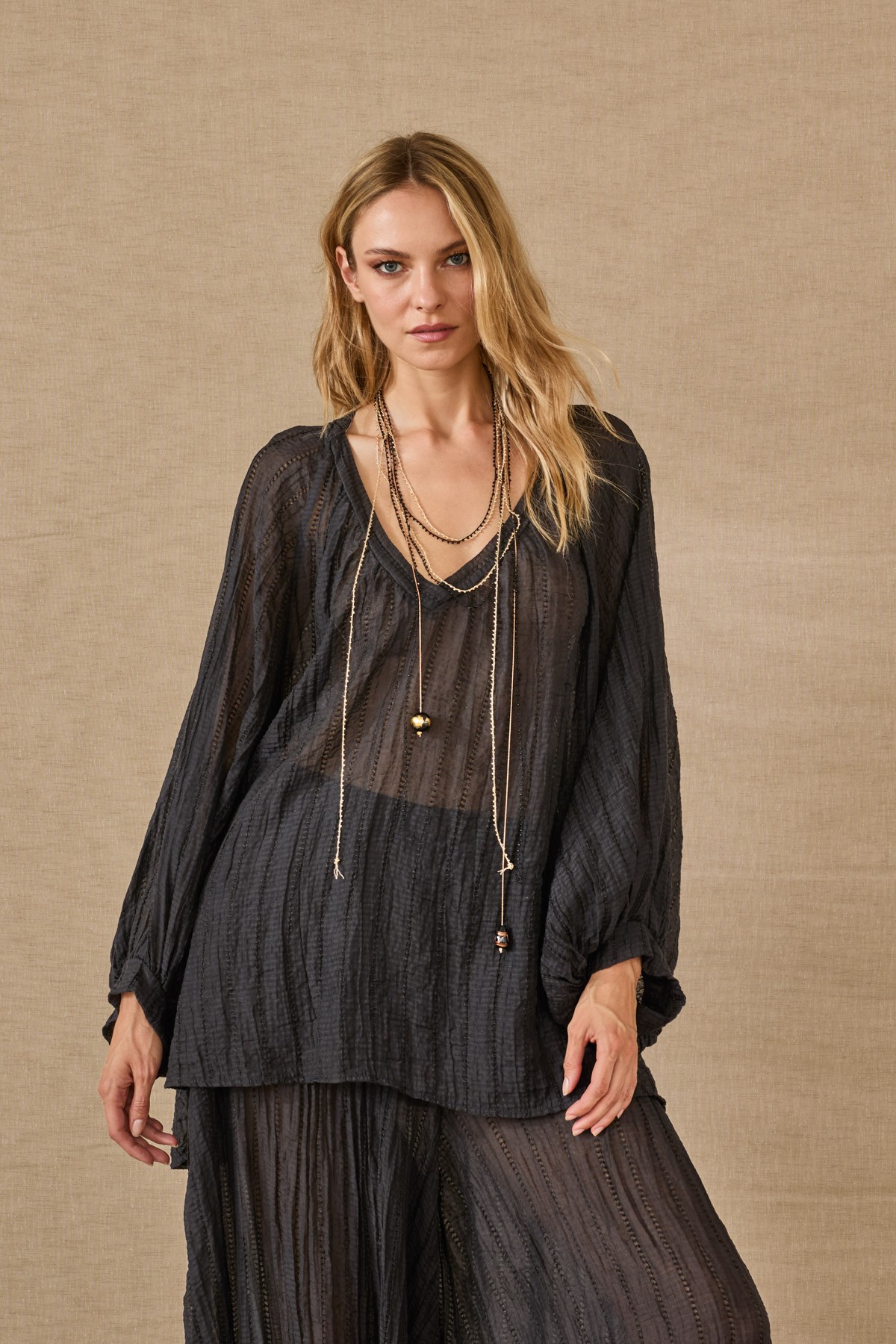 Light, flowy blouse with sleeves. For a complete look, pair them with the  pants from the same collection.