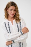 Cotton blouse with embroidery. It has a V-neck and a loose, comfortable fit.